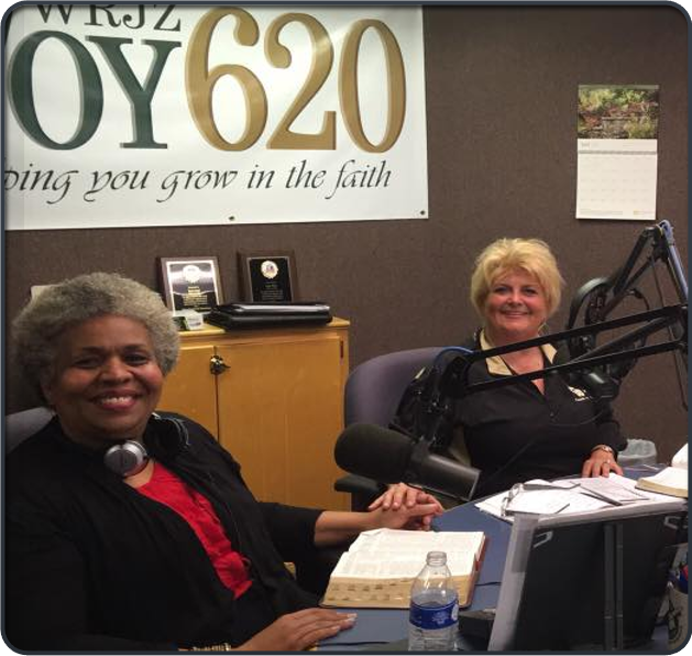 2 women sitting in a radio booth